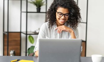 A woman working from home office at a desk and laptop for blog post remote jobs that pay $30 per hour