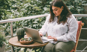 A plus sized woman working on her laptop looking for short task jobs