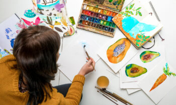 A woman painting to sell art online