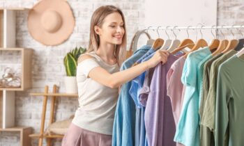 A woman looking through clothing items on a rack.