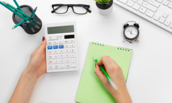 Woman using a calculator to determine the best frugal living tips for her family